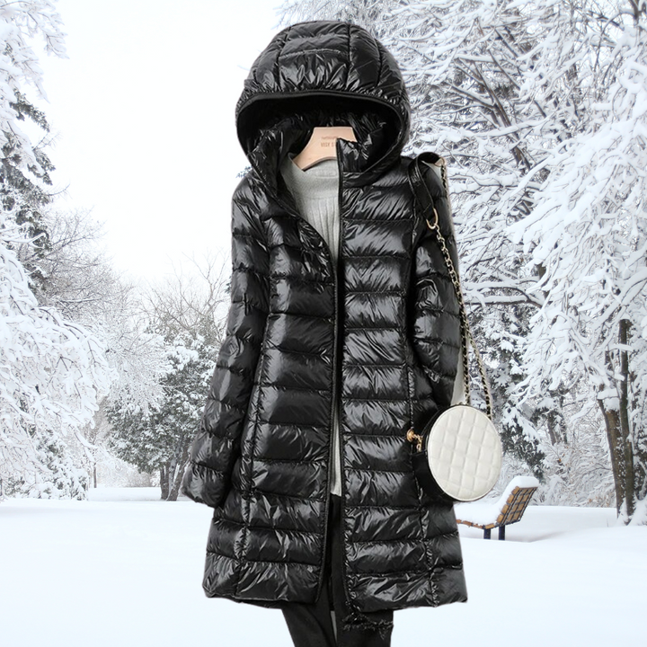 Woman wearing the black Seraphina ultralight down jacket, walking outdoors, highlighting its versatile style.