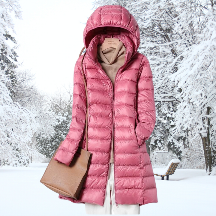 The Seraphina ultralight down jacket folded into its compact pouch, emphasizing its packable feature.