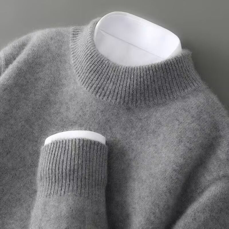 Side profile of a green cashmere sweater on a model, illustrating the relaxed fit and overall silhouette.