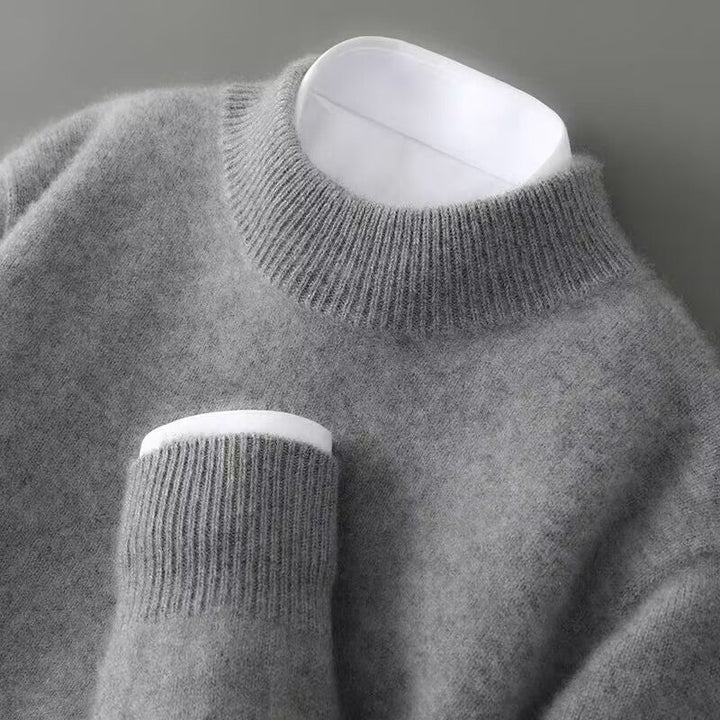 Side profile of a green cashmere sweater on a model, illustrating the relaxed fit and overall silhouette.