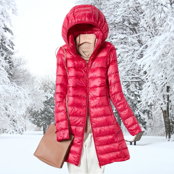 A model zipping up the red Seraphina ultralight down jacket, focusing on the quality zipper and chin guard.