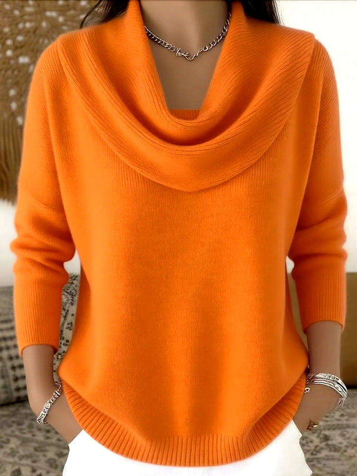Lifestyle shot of a woman comfortably seated in the pink Seraphina sweater, perfect for relaxed moments.