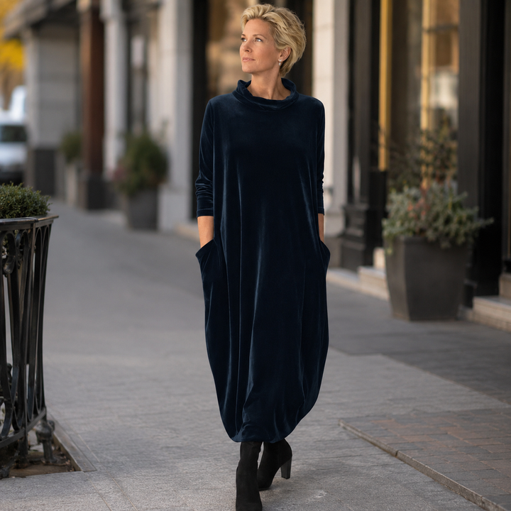 Back view of the purple velvet maxi dress, emphasizing the graceful drape of the fabric.