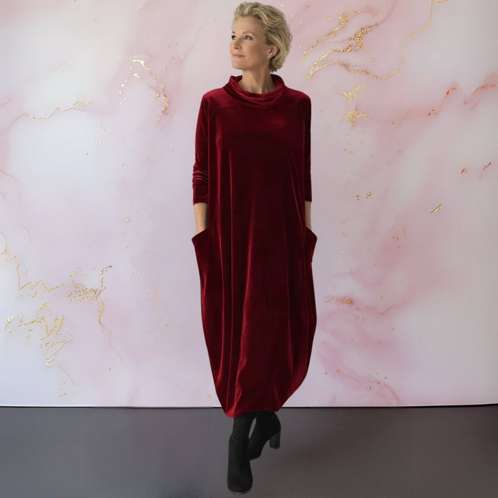 Lifestyle shot of the Serena velvet dress worn at an evening gathering, exuding sophistication.