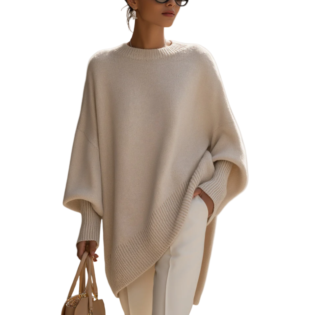 Side profile of the elegant Solana poncho pullover, highlighting its wide sleeves and flowing silhouette.