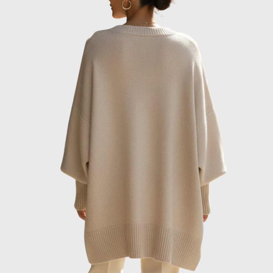 Detailed close-up of the fine knit texture of the Solana oversize poncho pullover, in a rich navy blue hue.