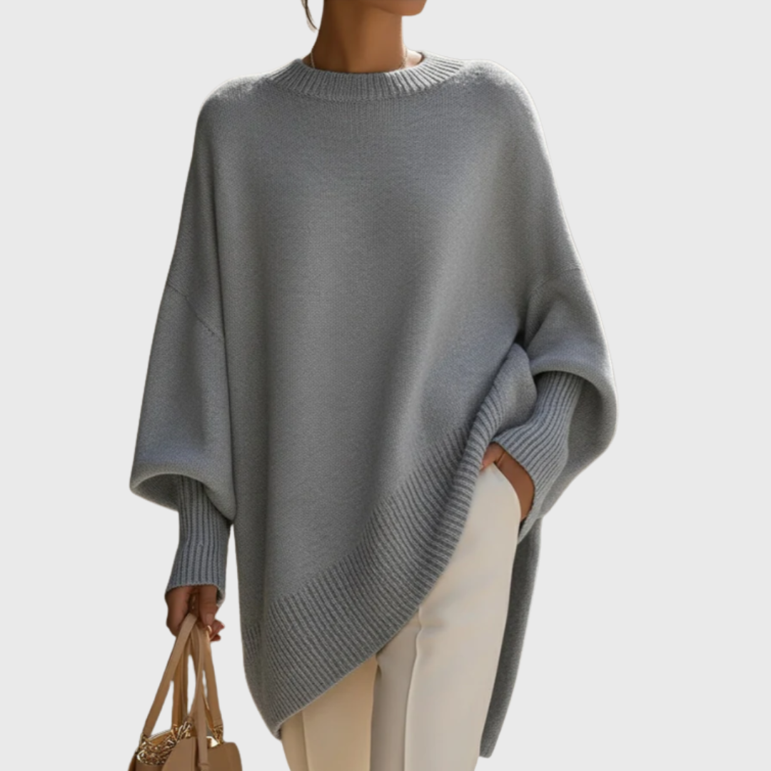 Close-up of the neckline and shoulder of the black Solana oversize poncho pullover, emphasizing the relaxed fit.