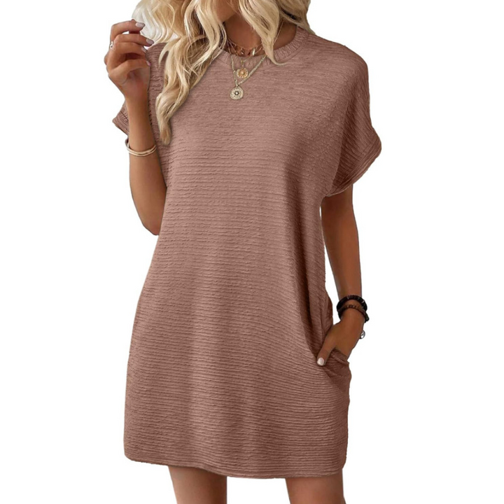 Woman posing in a light brown Valerie casual round neck dress, emphasizing its versatile and timeless appeal.
