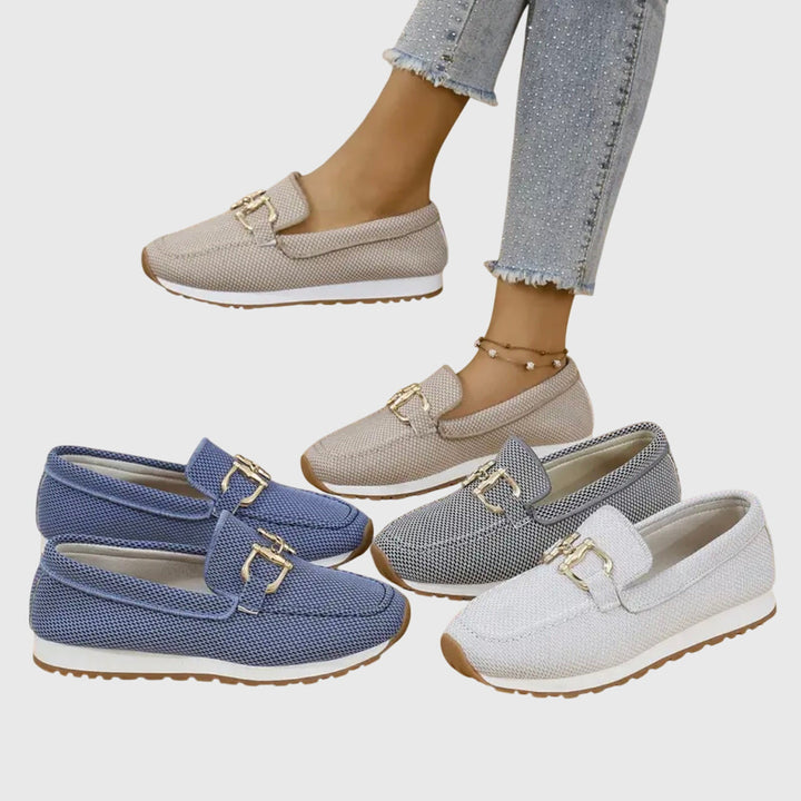 Product shot of the white orthopedic loafer sneakers from a slightly elevated angle, highlighting their clean, versatile design.