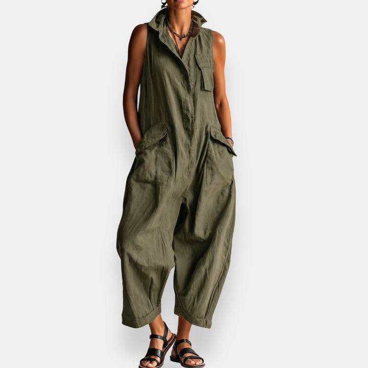 Close-up detail of the open stand collar on a green relaxed sleeveless jumpsuit, focusing on the neckline.