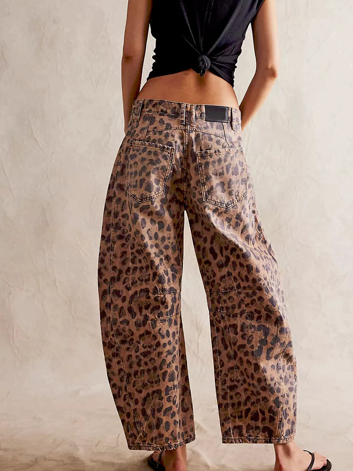 Detail of the four-pocket styling on the front of the fashionable leopard print jeans.