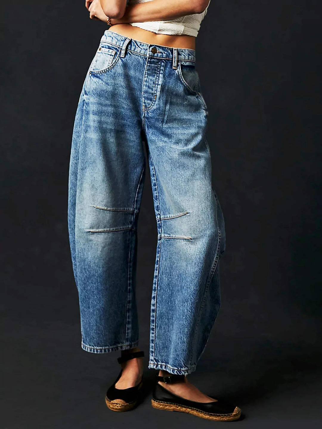Side profile of the leopard print barrel jeans, highlighting the slouchy fit and ankle-length cut.