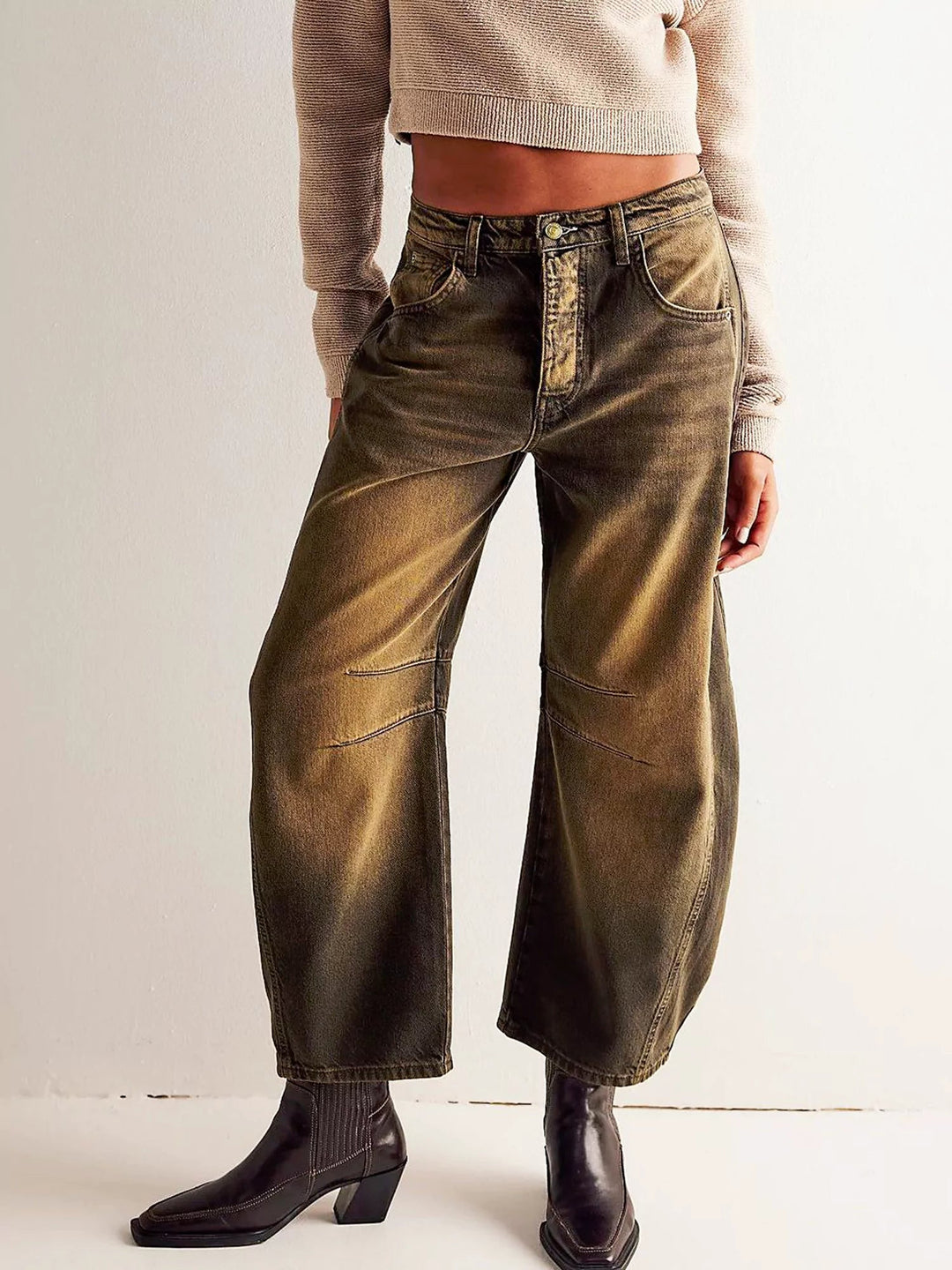 View of the tapered hemline and subtle distressing on the ankle of the stylish leopard print jeans.