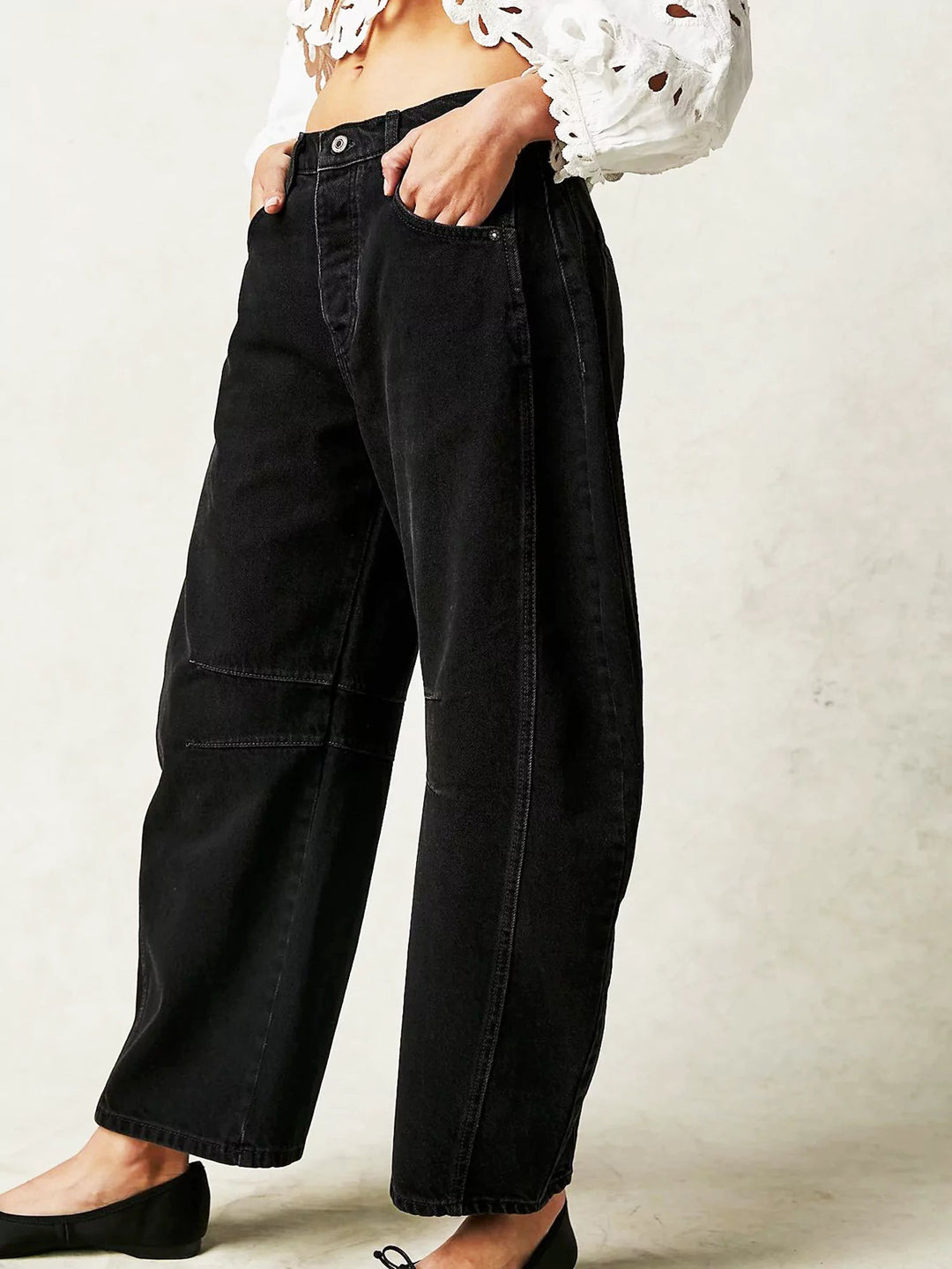 Close-up of the denim texture and the intricate leopard spots on the barrel jeans.